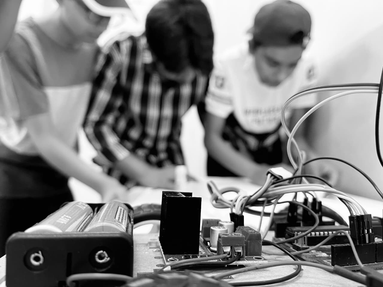 Students debugging a robotics project together